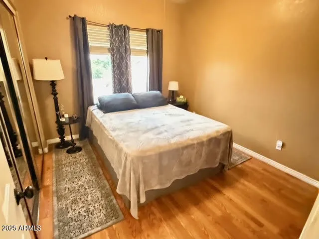 a bed sitting in a bedroom next to a window