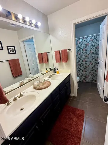 a bathroom with a sink double vanity and a mirror