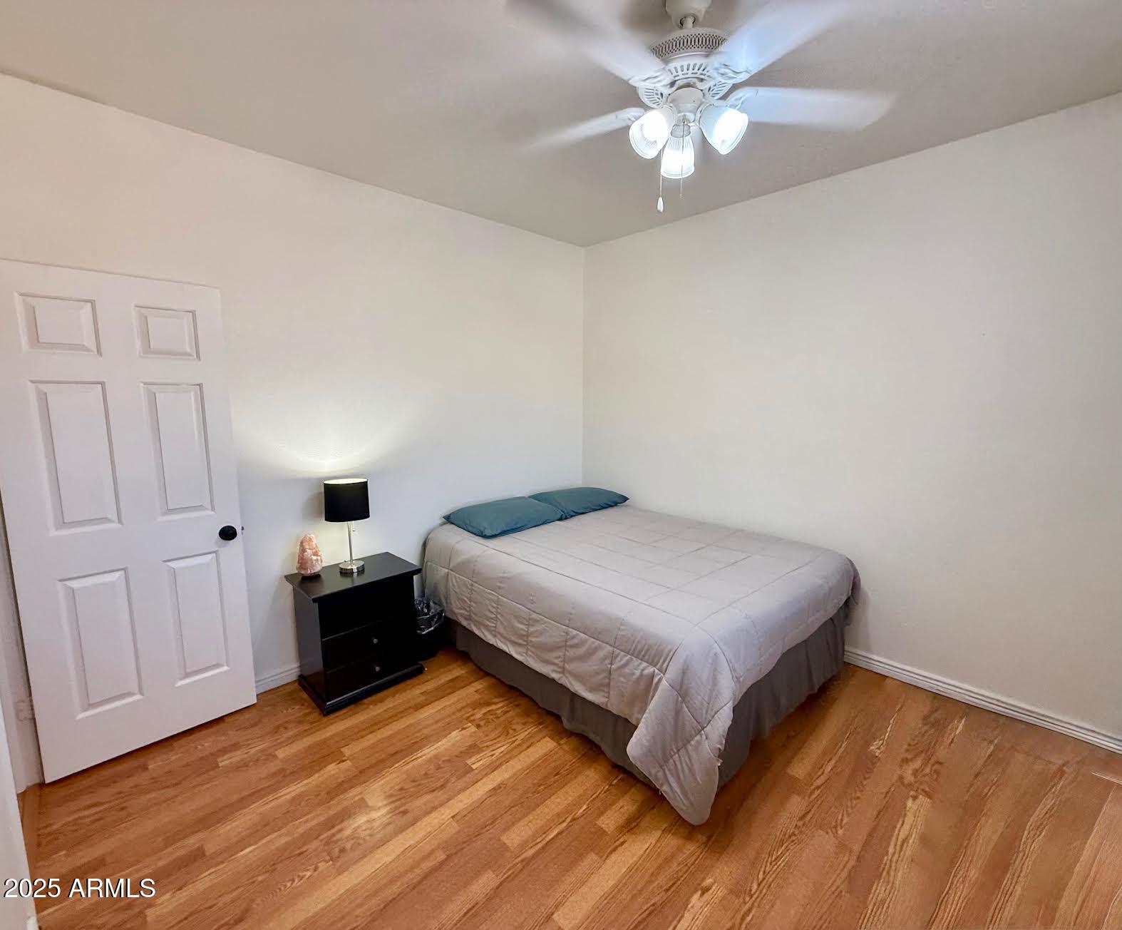 6743 East Tyndall Circle Mesa, AZ 85215 - Photo 22 of 27 a bedroom with a bed and a chandelier