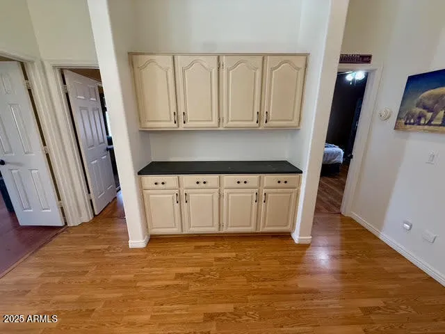 a view of a kitchen with wooden floor and electronic appliances
