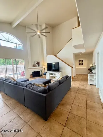 a living room with stainless steel appliances kitchen island granite countertop furniture a rug and a window