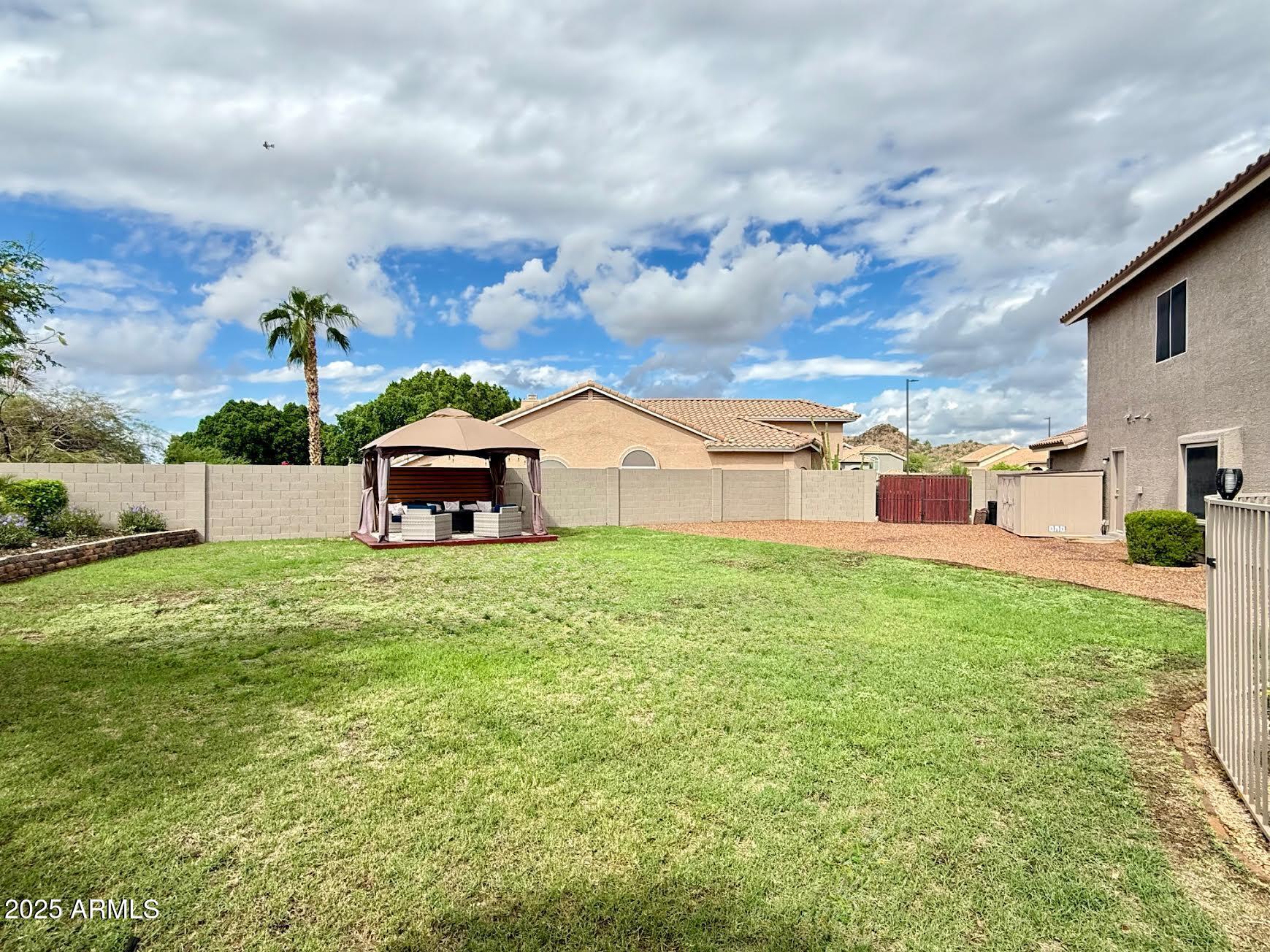 6743 East Tyndall Circle Mesa, AZ 85215 - Photo 6 of 27 a backyard of a house with table and chairs