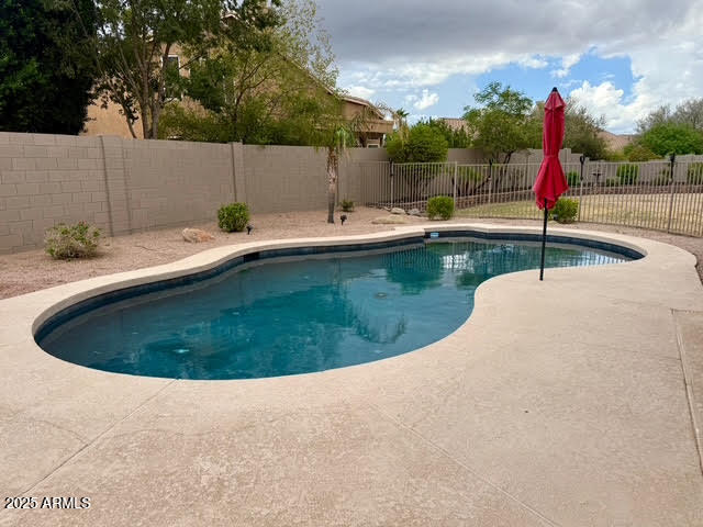6743 East Tyndall Circle Mesa, AZ 85215 - Photo 8 of 27 a view of a swimming pool with a yard