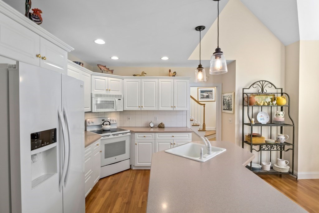 29 Spruce Road Harwich, MA 02645 - Photo 15 of 41 a kitchen with stainless steel appliances granite countertop a sink refrigerator and cabinets