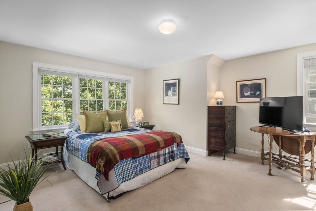 29 Spruce Road Harwich, MA 02645 - Photo 21 of 41 a bedroom with a bed table chair and a window