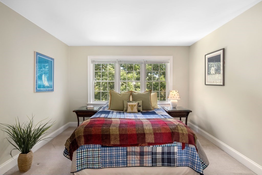 29 Spruce Road Harwich, MA 02645 - Photo 22 of 41 a bedroom with a large bed and a window