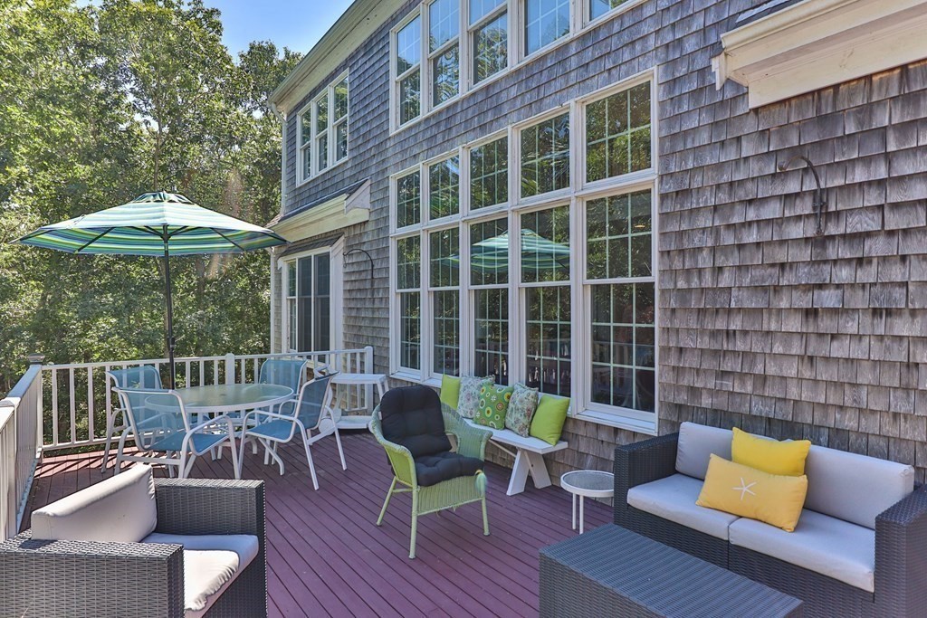 29 Spruce Road Harwich, MA 02645 - Photo 30 of 41 a view of a patio with couches chairs and wooden floor