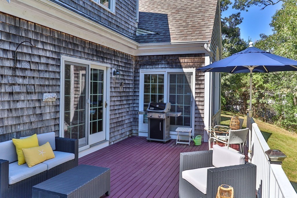 29 Spruce Road Harwich, MA 02645 - Photo 31 of 41 an outdoor sitting area with furniture and wooden floor