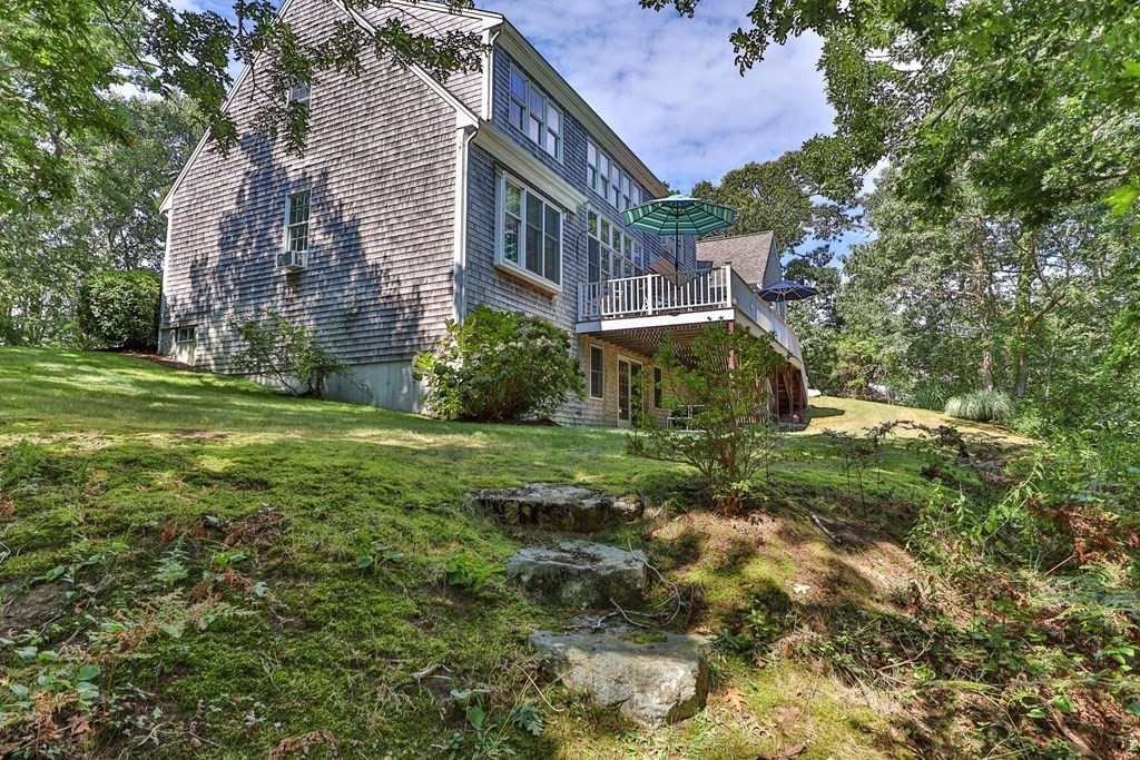 29 Spruce Road Harwich, MA 02645 - Photo 5 of 41 a view of a big yard next to a building