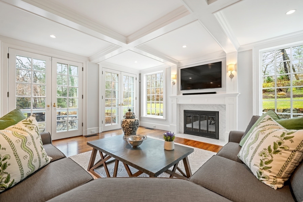17 Ravine Road Wellesley, MA 02481 - Photo 18 of 42 a living room with furniture a fireplace and a flat screen tv