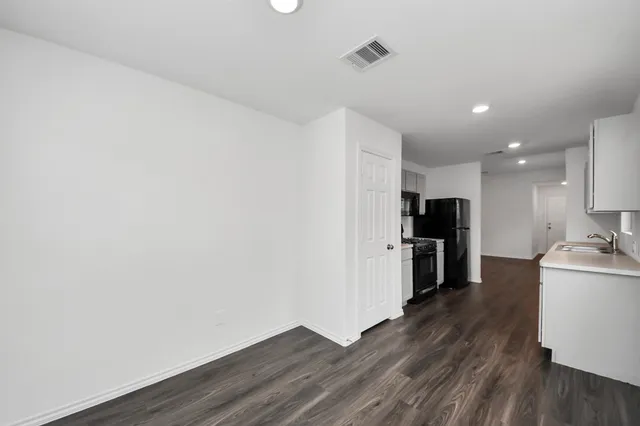 an empty room with windows and closet