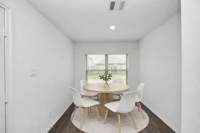 a view of a dining room with furniture and window