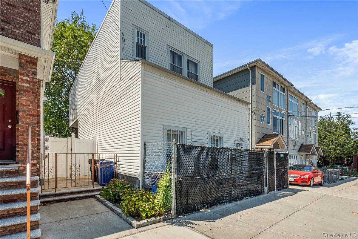 80-10 59th Street Queens, NY 11385 - Photo 2 of 7 a front view of a house with garage