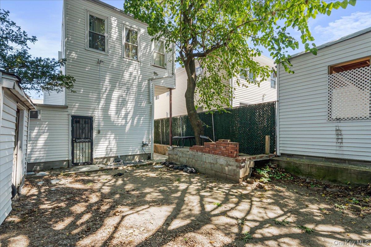 80-10 59th Street Queens, NY 11385 - Photo 6 of 7 a backyard of a house with seating space