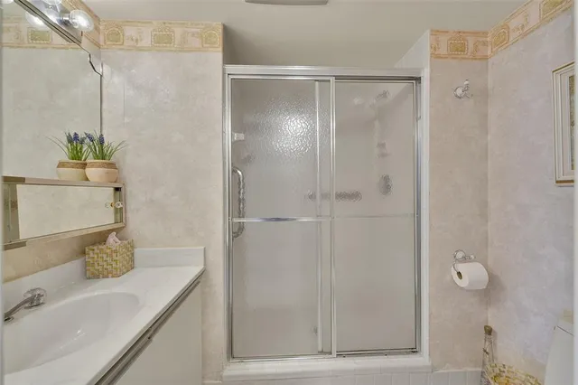 a bathroom with a shower and a sink