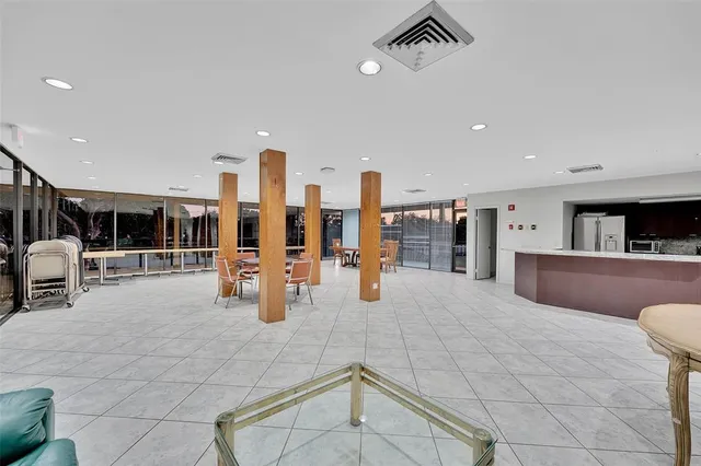 a lobby with furniture and view of living room
