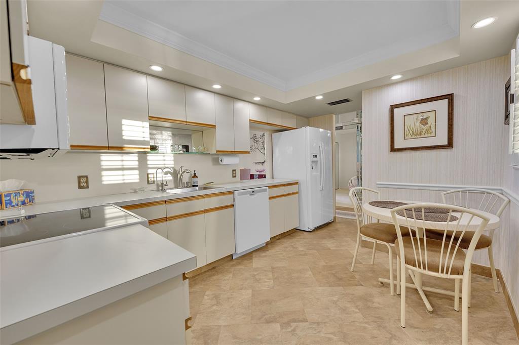 5340 Northwest 2nd Avenue, Unit PH26 Boca Raton, FL 33487 - Photo 28 of 53 a kitchen with a sink a counter top space stainless steel appliances and cabinets