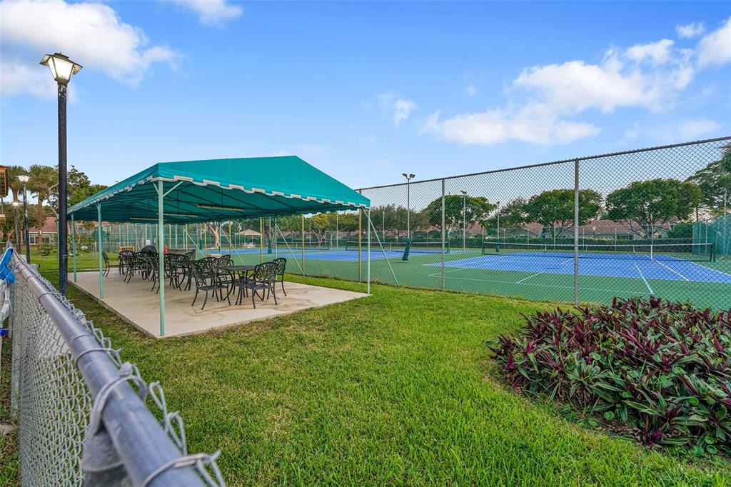 5340 Northwest 2nd Avenue, Unit PH26 Boca Raton, FL 33487 - Photo 36 of 53 a view of a chair and table in the garden