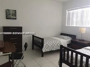 a bedroom with a bed and a table in it