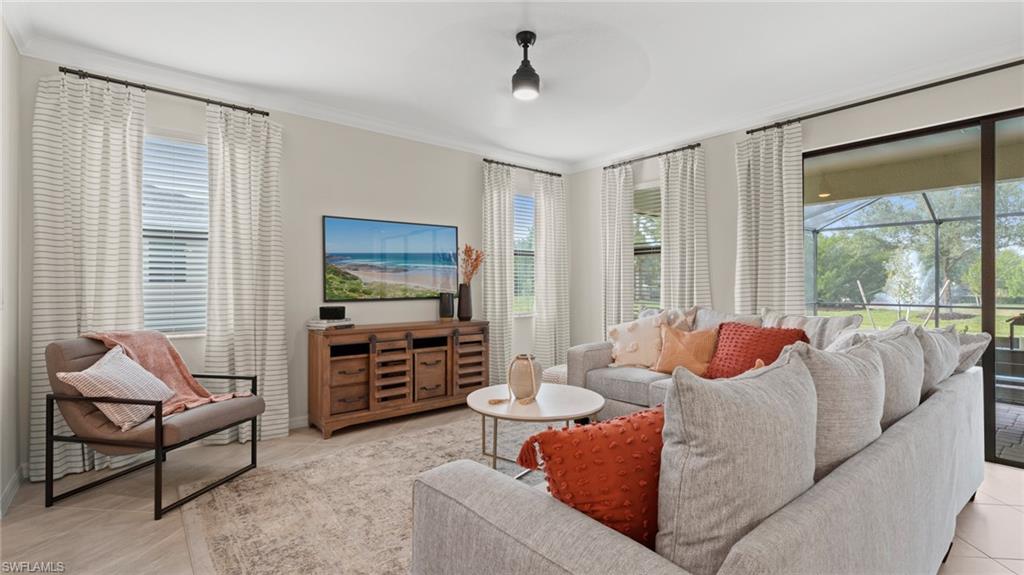 20641 Copperhead Drive Lehigh Acres, FL 33936 - Photo 9 of 27 a living room with furniture and large windows