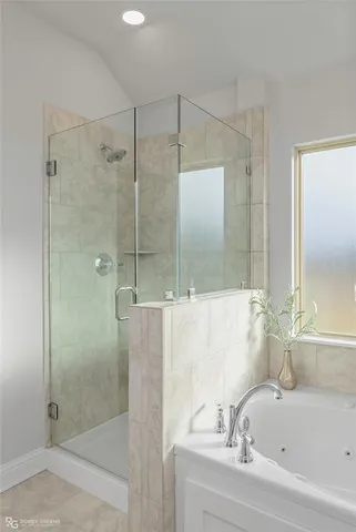 a bathroom with a bathtub and a shower