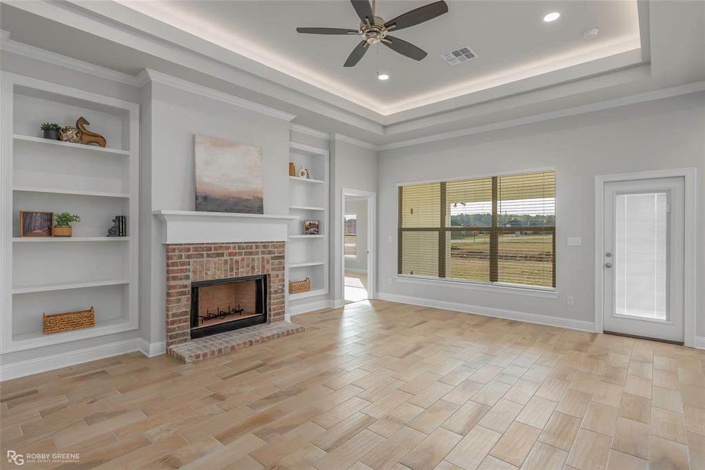 727 Bianca Street Haughton, LA 71037 - Photo 2 of 22 a view of an empty room with a fireplace and a window