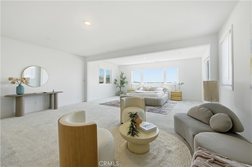 20164 Galway Lane Porter Ranch, CA 91326 - Photo 31 of 48 Light-filled primary bedroom with generous scale and seating lounge