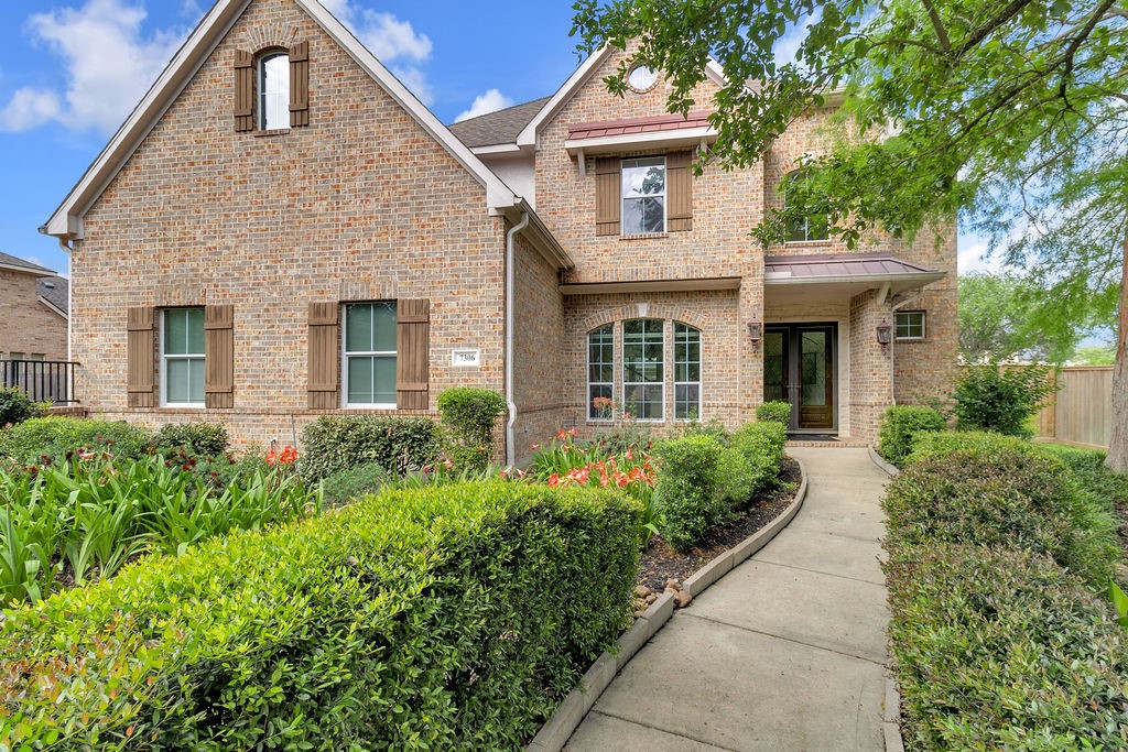 7306 Starflower Katy, TX 77494 - Photo 3 of 50 a front view of a house with garden