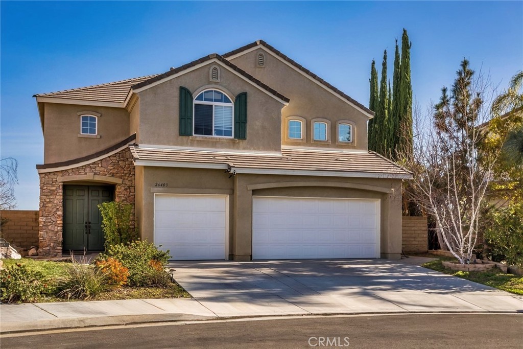 a view of a house with a yard and garage