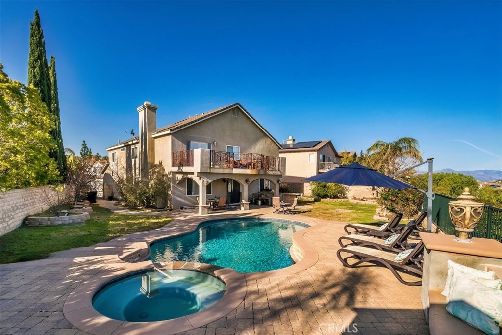 26403 Ocasey Place Stevenson Ranch, CA 91381 - Photo 11 of 27 a view of a house with swimming pool and sitting area
