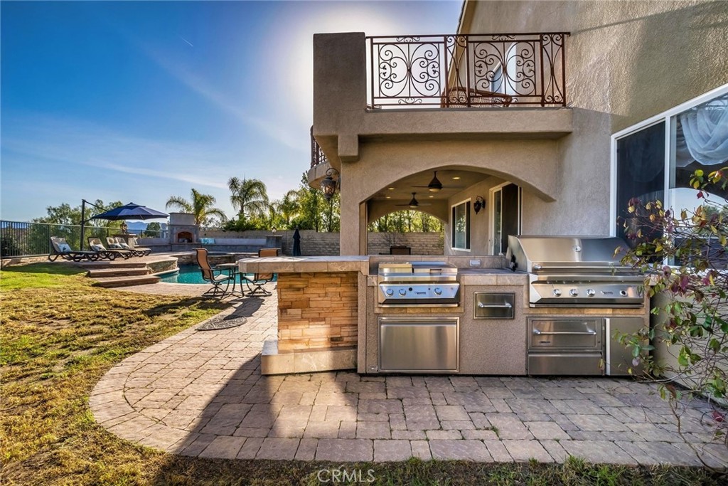 26403 Ocasey Place Stevenson Ranch, CA 91381 - Photo 14 of 27 a kitchen with stainless steel appliances granite countertop a stove and cabinets