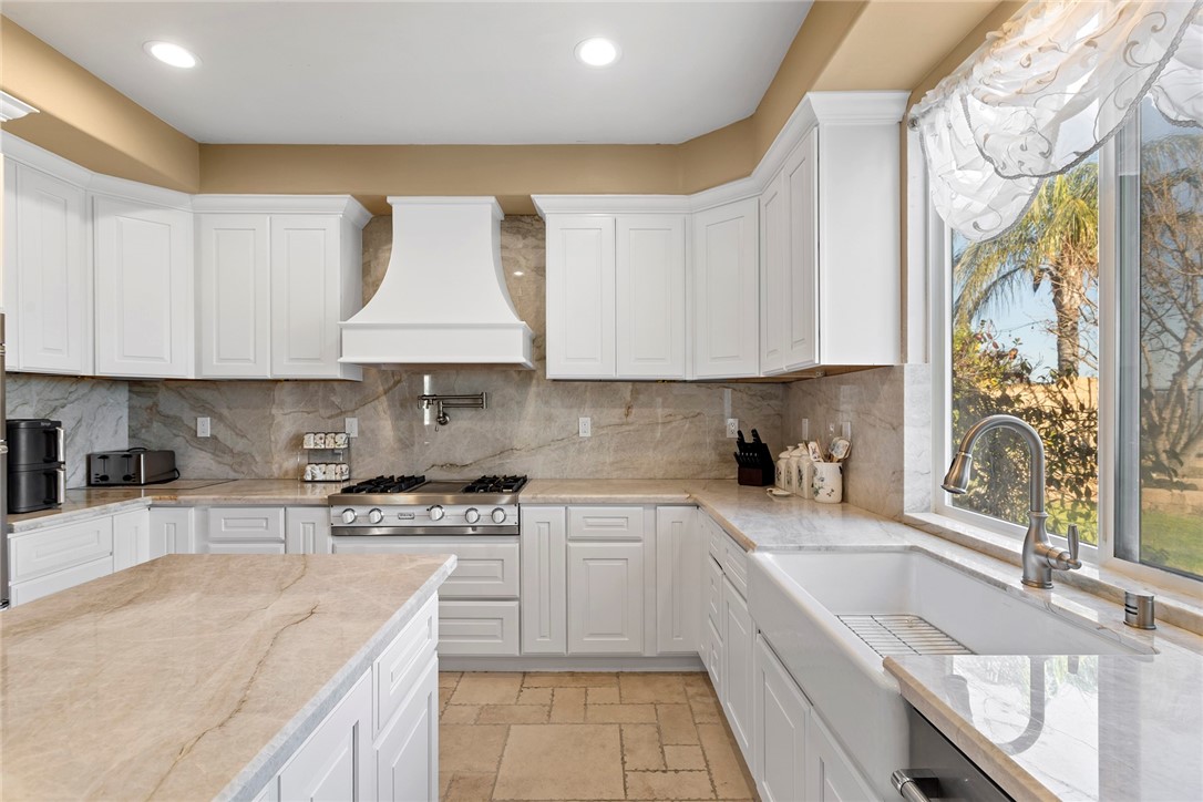 26403 Ocasey Place Stevenson Ranch, CA 91381 - Photo 7 of 27 a kitchen with stainless steel appliances granite countertop a sink stove and cabinets