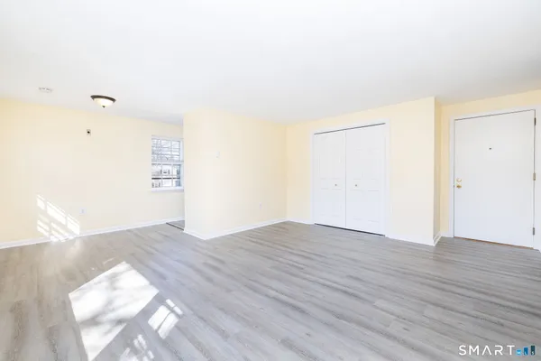 a view of an empty room and wooden floor
