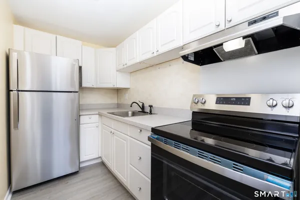 a kitchen with appliances and cabinets