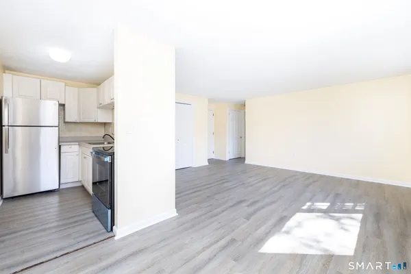 a view of kitchen view wooden floor and electronic appliances