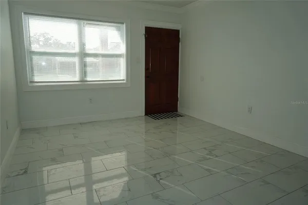 a view of an empty room with a window