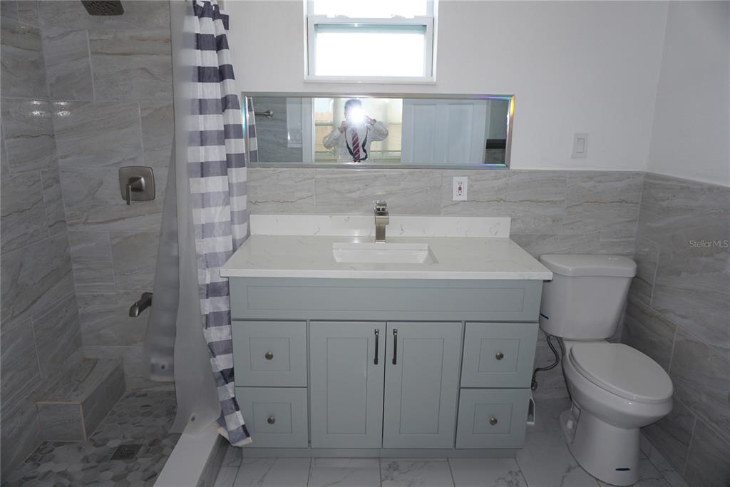 7173 63rd Street North Pinellas Park, FL 33781 - Photo 9 of 15 a bathroom with a sink toilet and shower