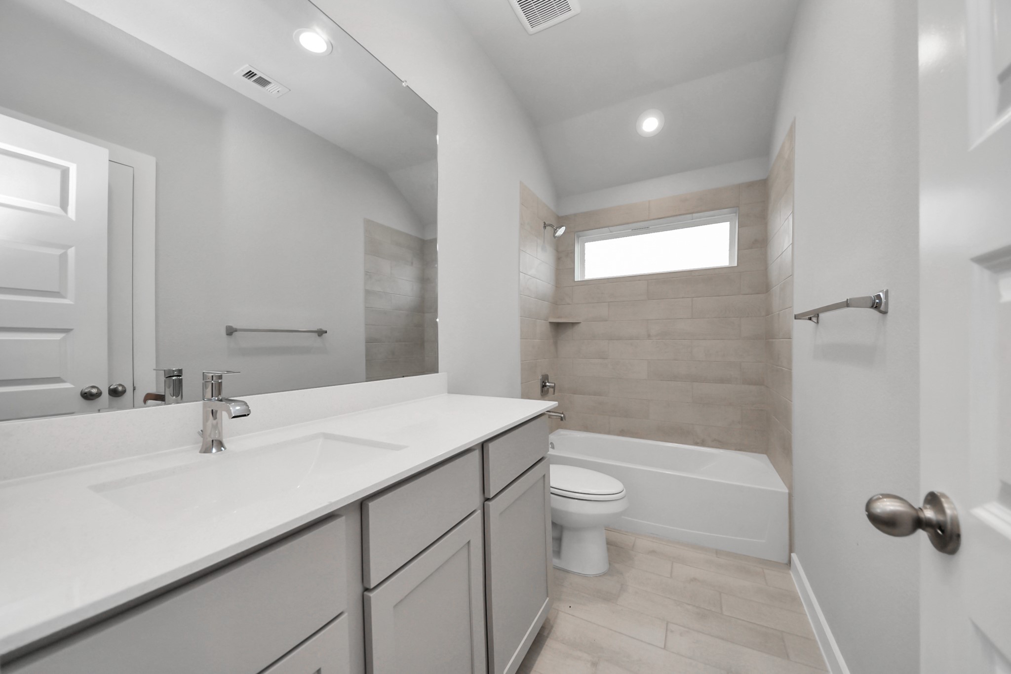 24518 Broad Park Spring, TX 77373 - Photo 6 of 29 Secondary bath features tile flooring, bath/shower combo with tile surround, light stained wood cabinets, beautiful light countertop. Sample photo of completed home with similar floor plan. Actual colors and selections may vary.