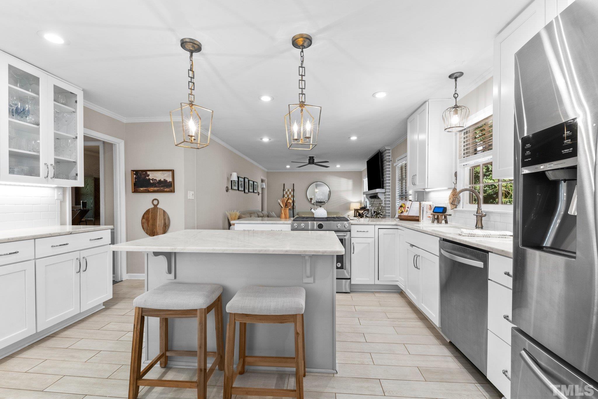 6704 Valley Drive Raleigh, NC 27612 - Photo 11 of 39 a kitchen with stainless steel appliances granite countertop a sink refrigerator and cabinets