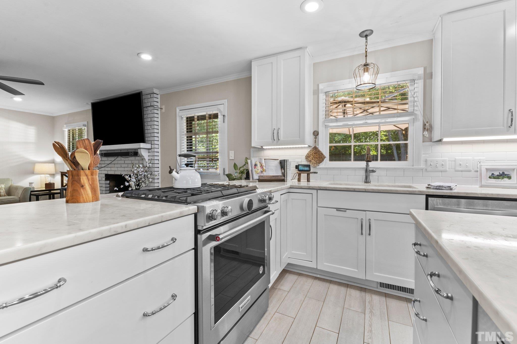 6704 Valley Drive Raleigh, NC 27612 - Photo 12 of 39 a kitchen with a sink stove and microwave