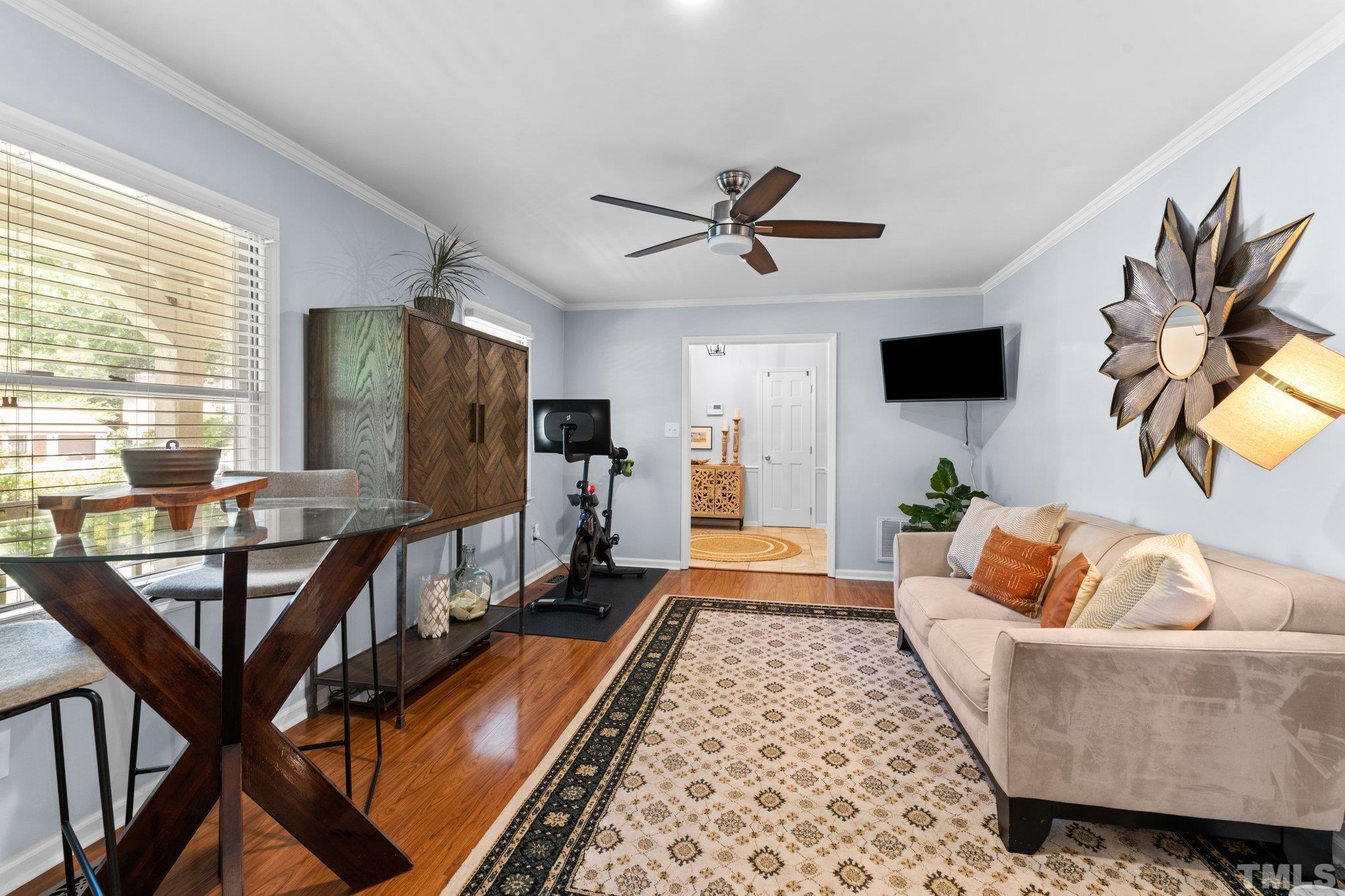 6704 Valley Drive Raleigh, NC 27612 - Photo 18 of 39 a living room with furniture and a flat screen tv