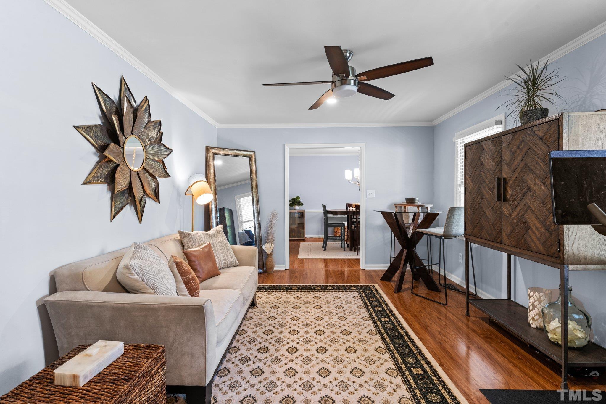 6704 Valley Drive Raleigh, NC 27612 - Photo 19 of 39 a living room with furniture and a flat screen tv