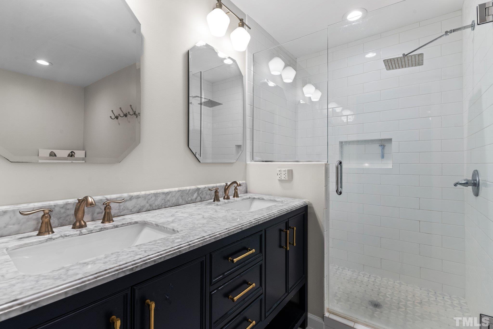 6704 Valley Drive Raleigh, NC 27612 - Photo 22 of 39 a bathroom with a granite countertop sink a large mirror and shower