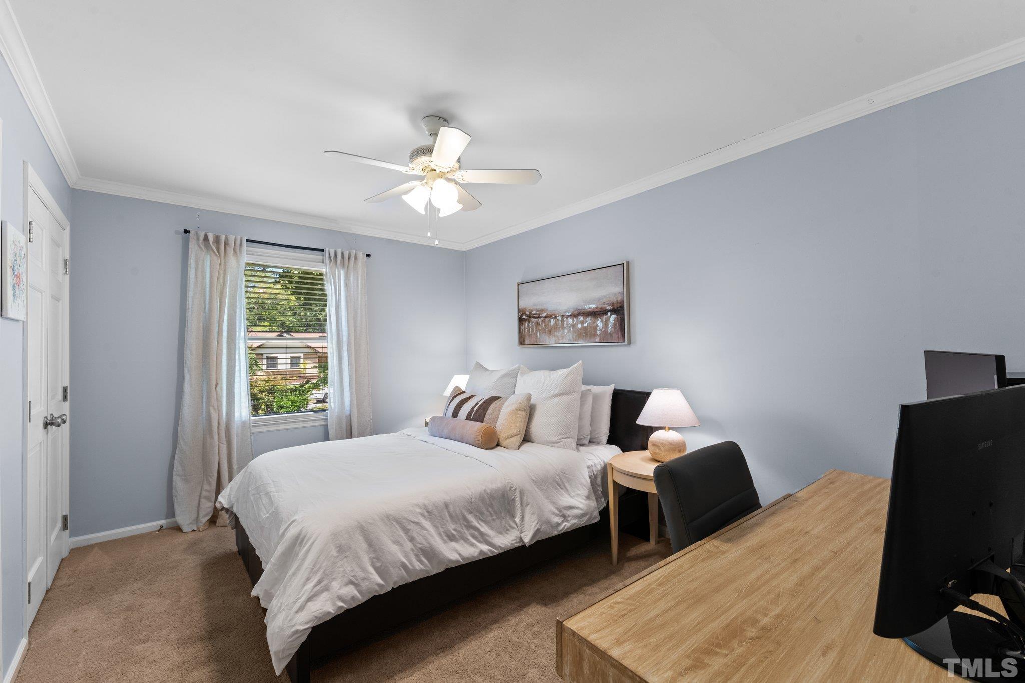 6704 Valley Drive Raleigh, NC 27612 - Photo 25 of 39 a bedroom with a bed and a flat screen tv