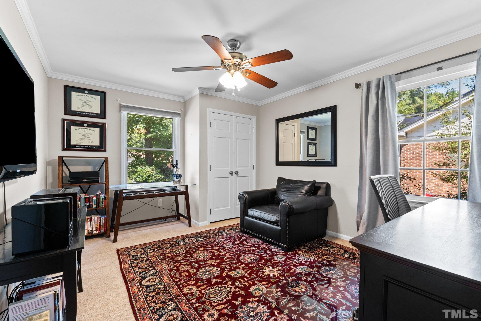 6704 Valley Drive Raleigh, NC 27612 - Photo 28 of 39 a living room with furniture a flat screen tv and a window