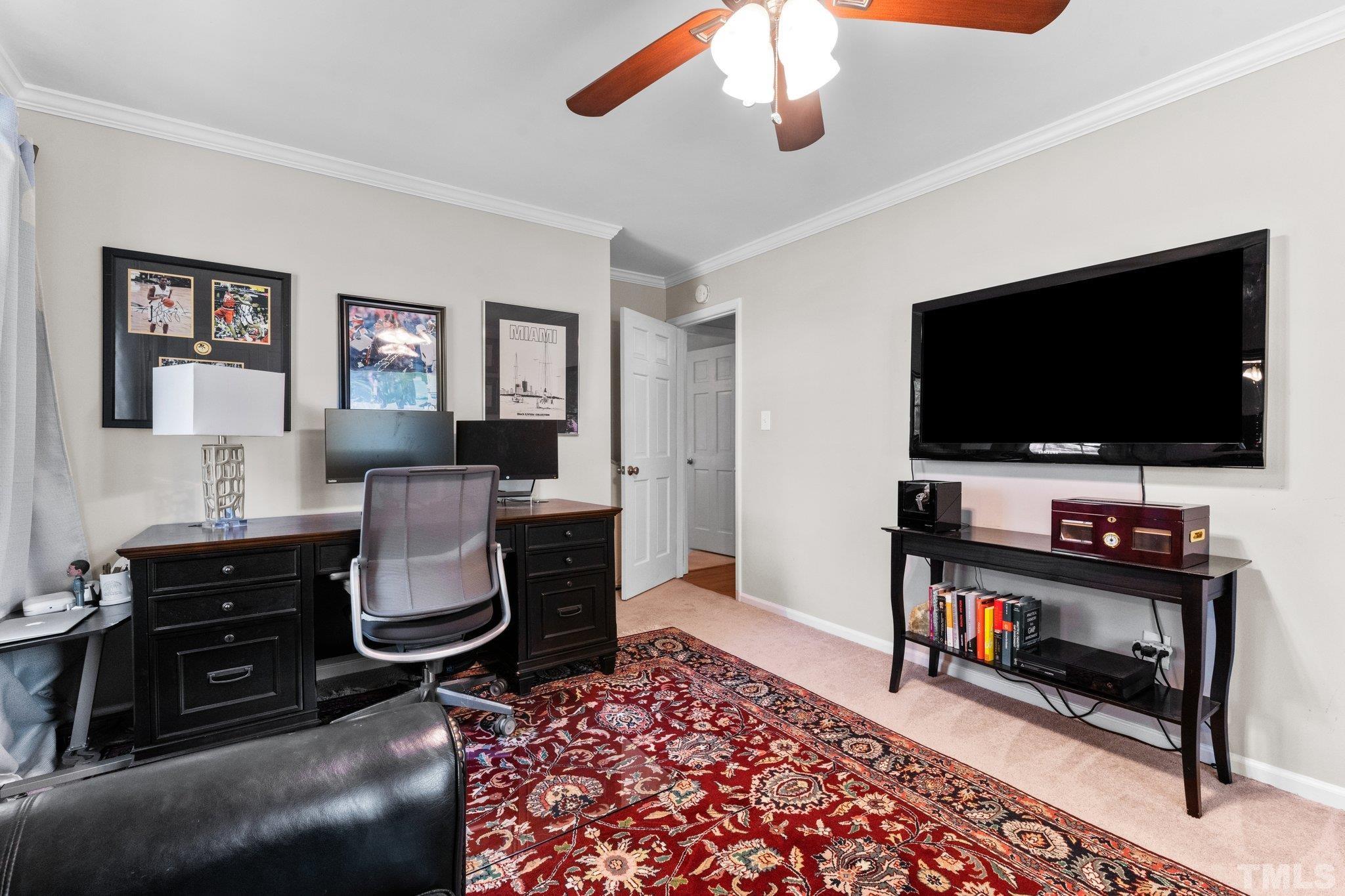6704 Valley Drive Raleigh, NC 27612 - Photo 29 of 39 a living room with furniture and a flat screen tv