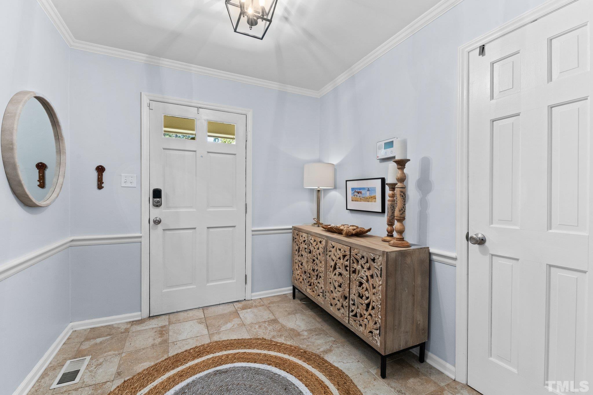 6704 Valley Drive Raleigh, NC 27612 - Photo 6 of 39 a bedroom with a bed and a chandelier