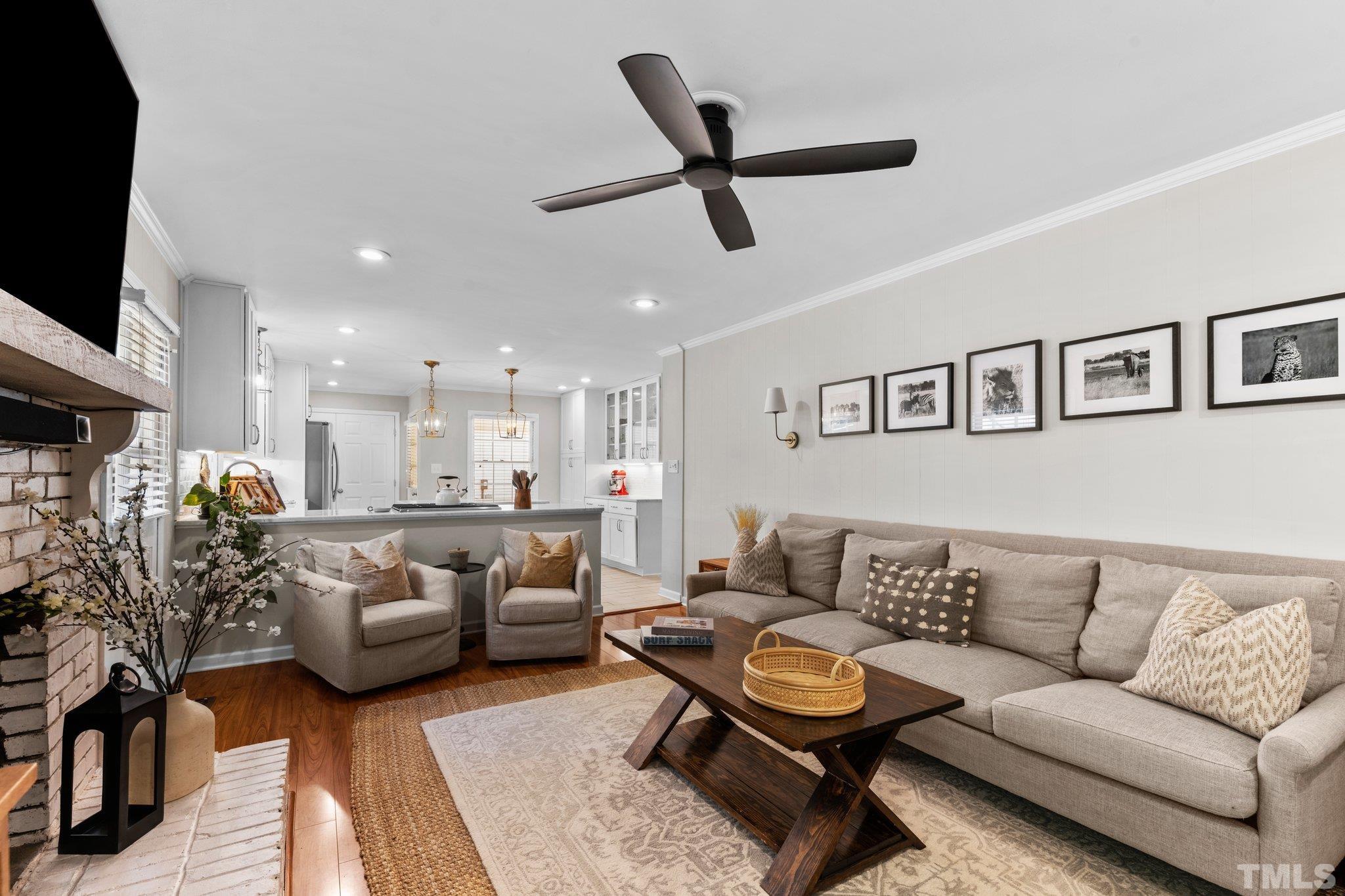 6704 Valley Drive Raleigh, NC 27612 - Photo 8 of 39 a living room with furniture and a flat screen tv