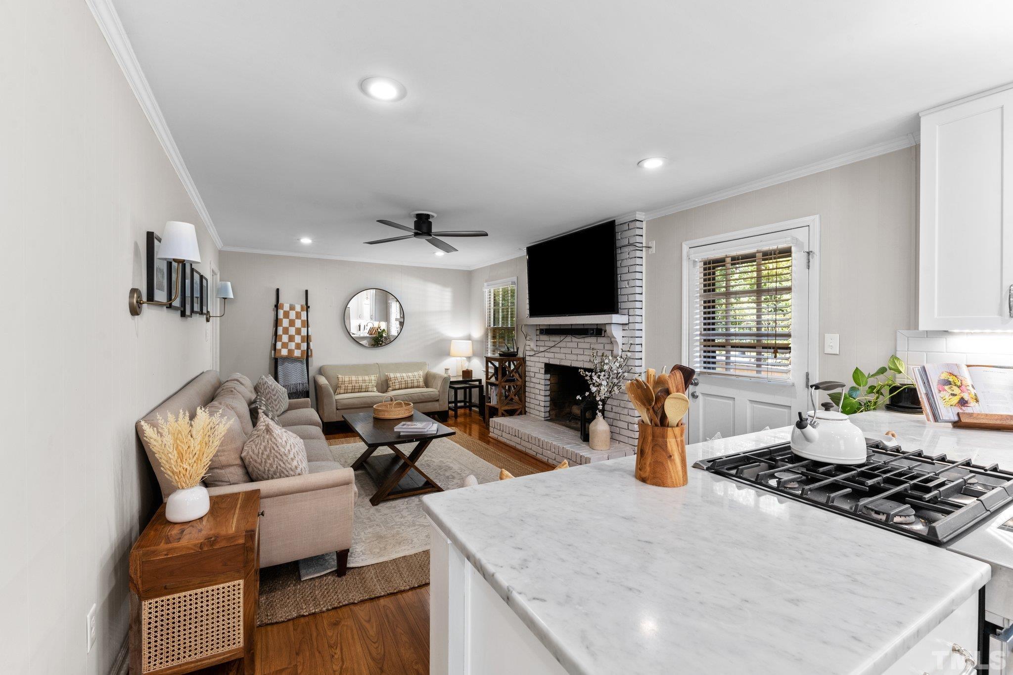 6704 Valley Drive Raleigh, NC 27612 - Photo 10 of 39 a living room with fireplace furniture and a flat screen tv