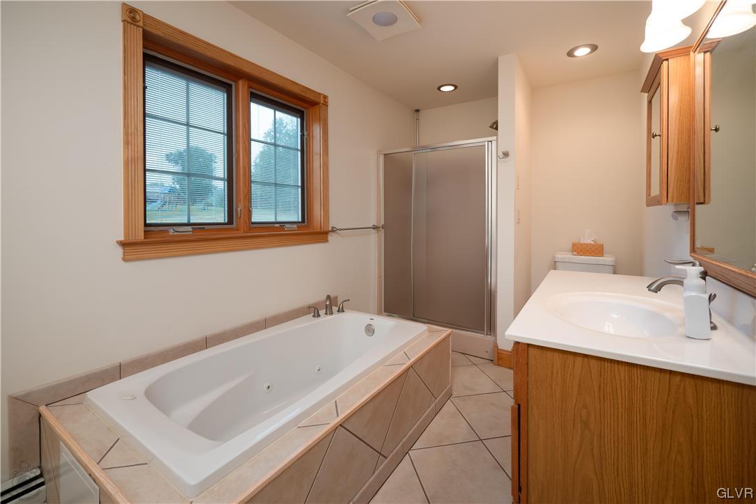 2174 Blue Barn Road Orefield, PA 18069 - Photo 15 of 23 a bathroom with a tub sink and mirror